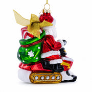 Santa Delivering Gifts on a Snowmobile Glass Christmas Ornament